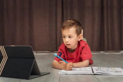 A small smart child learns remotely Stock Photos
