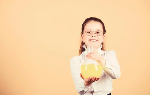 Small smart girl with testing flask. education and knowledge. child study bilogy 写真素材