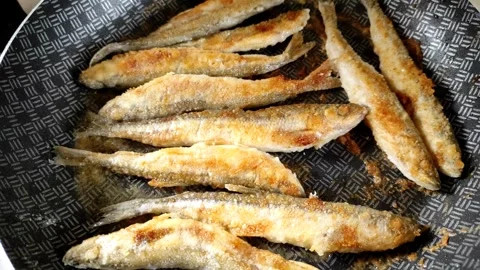 Small smelt fish is fried in a pan. Stock Footage 252089646
