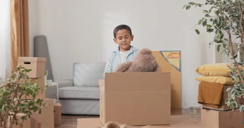 A small smiling sweet boy after moving into a new apartment looks among the Stock Footage 170205641
