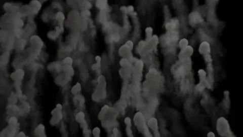 Small smoke clouds rise up and form columns of gray smoke against a black Video stock 170639582