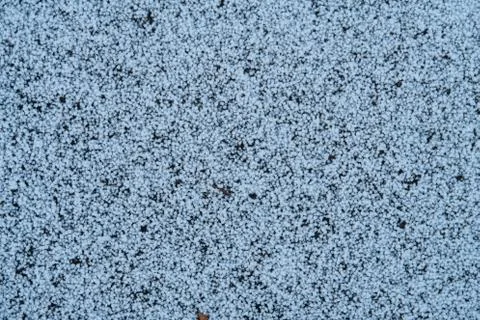 Small snow pellets on a dark background, winter background Stock Photos