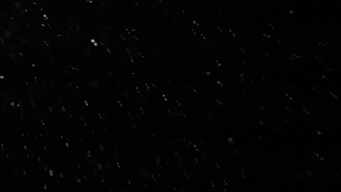 Small snowflakes whirl and fall on a black background. Night snowfall before Stock Footage 173149496