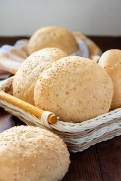 Small soft rolls with a crispy crust sprinkled with sesame seeds in a basket Stock Photos