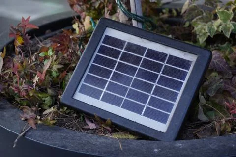 A small solar cell designed to generate low-power electricity outdoors, surro Stock Photos
