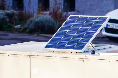 Small solar panel installed on a white rooftop unit for renewable energy ge.. Stock Photos