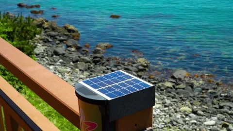 Small solar panel on wooden railing of Haeundae Blue Line Park seaside walkway 動画素材 336664469