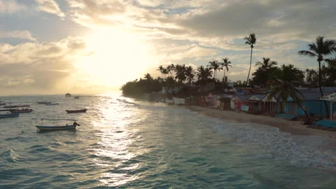 Small souvenir huts crowd the beach near a resort in Punta Cana Stock Footage 317941114