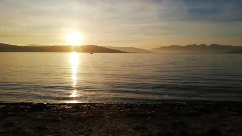 Small speedboat in the distance during a sunset by the sea Stock-Footage 169396201