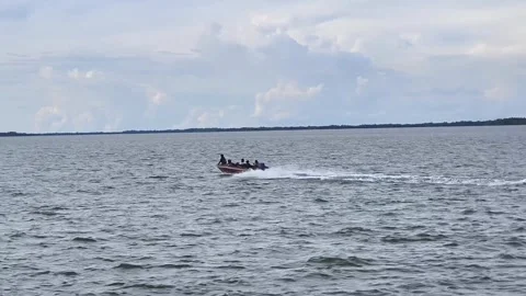 A small speedboat with passengers moving so fast Stock Footage 336675225