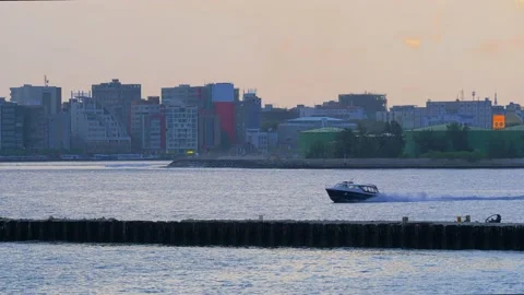 A small speedboat sails along the calm waters from right to left Video stock 144789232