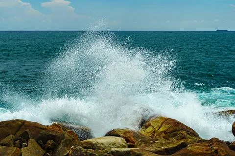 Small splashes from the waves hit the rocks Stock Photos