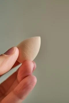 Small sponge in a woman's hand. Stock Photos
