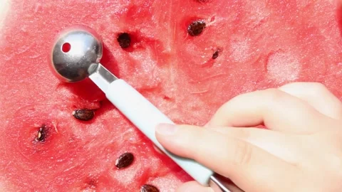 With a small spoon, cut small circles from a juicy ripe watermelon. Asmr. Video stock 281194996