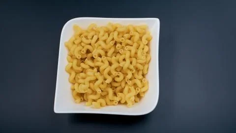 Small spring-shaped pasta. Pasta in a white plate, a plate with macaroni on a Stock Photos