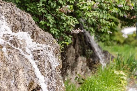 Small spring waterfall in the city Stock Photos