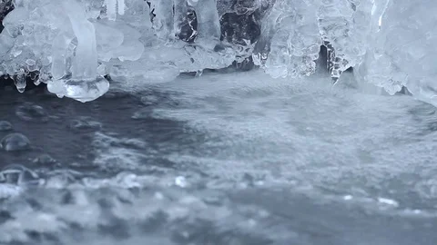 Small spring waterfall with ice and water flow Stock Footage 70073278