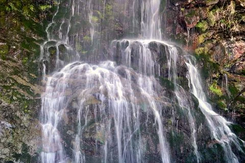 A small spring waterfall on the rocks Stock Photos