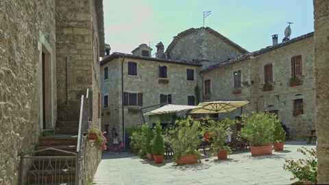 A small square between the medieval houses of the village of Castel Trasino Stock Footage 268895208