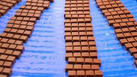Small square chocolates moving in neat rows Stock Footage 323354807
