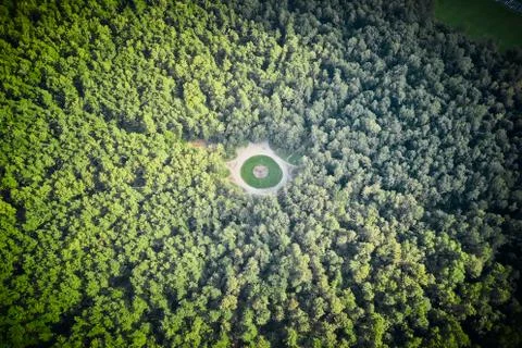 Small square in the middle of dense forest. High angle view from above. Stock Photos