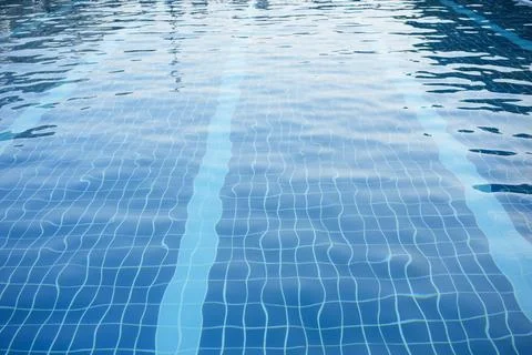 Small square tiles in the pool. Waves, reflection, lines Stock Photos