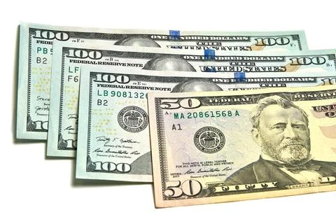 Small stack of 100 and 50 dollar bills, papers, finance. Stock Photos