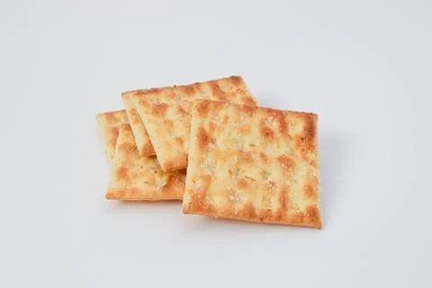 A small stack of five square, golden-brown cracker biscuits with sugar crys.. Stock Photos