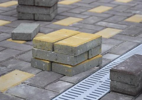 A small stack of paving slabs with a yellow face Stock Photos