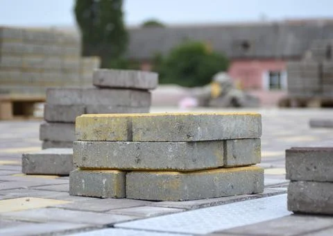 A small stack of paving slabs with a yellow face Stock Photos