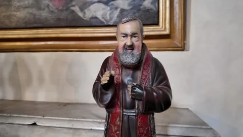Small statue of Saint Padre Pio on a devotional altar Stock Footage 338010452