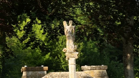 Small statuette in front of the trees Stock Footage 77265300