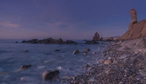 Small stone beach with three large rocks Fotos de archivo