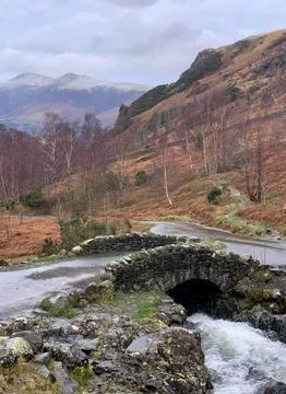 Small stone Bridge in the Mountains with a stream running underneath Stock Photos