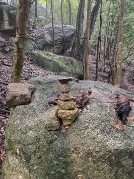 Small stone cairn in forest Japan Stock Photos