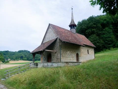 Small Stone Chapel with Bell Tower Near a Swiss Campsite, Forest Background Stock Photos