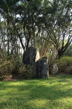 A small stone garden with three large stones in the center, surrounded by l.. Stock Photos