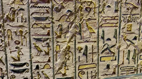A small stone with hand carved Ancient Egyptian hieroglyphics. This stone is Stock Footage 199670393