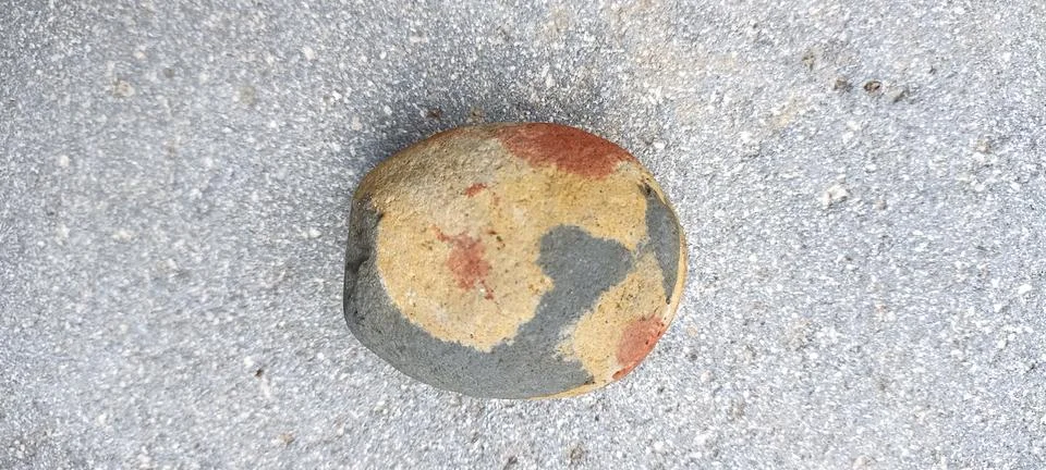 A small stone patterned with gray and light brown colors Stock Photos