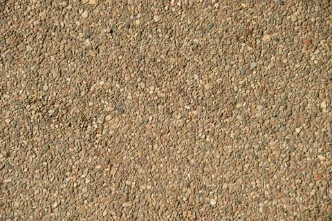Small stone pebble surface background texture. Top view. Stock Photos