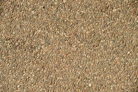 Small stone pebble surface background texture. Top view. Stock Photos