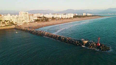 Small stone pier standing out on the beach in nuevo vallarta, mexico Stock Footage 304695720