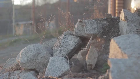 A small stone rolls over a pile of stones Stock Footage 89741090