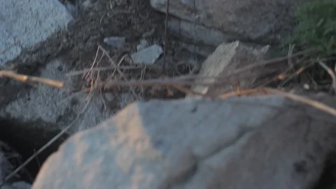 A small stone rolls over a pile of stones Stock Footage 89741100