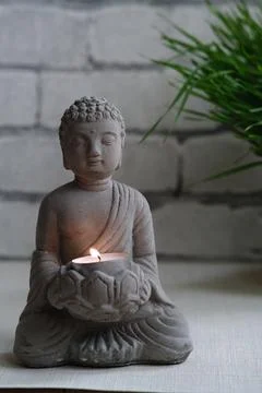 A small stone statue of Buddha Stock Photos