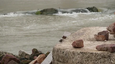 Small stones on Rocks, river running beneath and a big rock Stock Footage 225739724