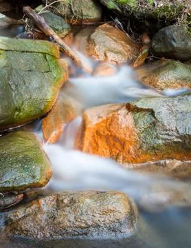 Small stream and rocks Stock Photos
