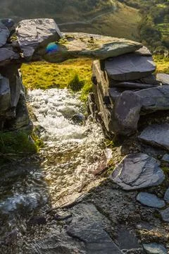 Small stream flooded path after rain storm. fast shutter. Stock Photos