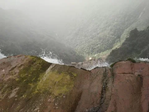 Small stream flow in mountain within green trees from top of mountain Stock Photos