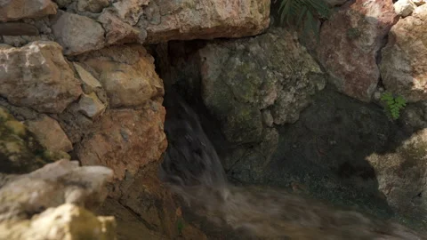 Small stream flowing between rocks Stock Footage 137964179